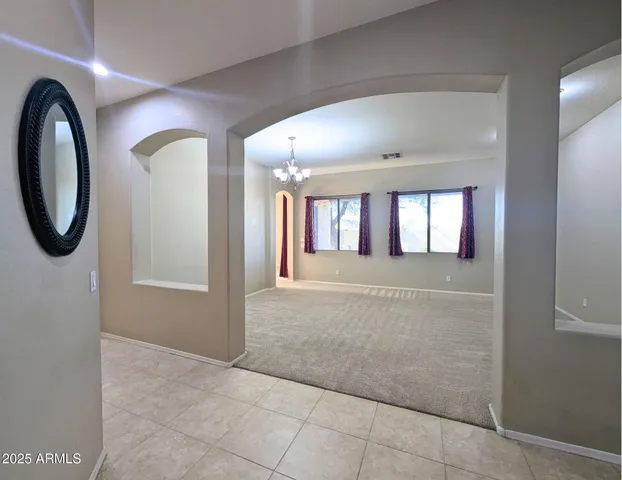 a view of hallway with livingroom and stairs