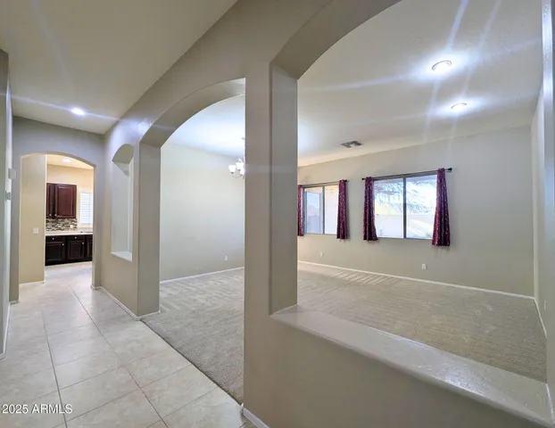 a large kitchen with stainless steel appliances granite countertop a stove a sink dishwasher a refrigerator and a oven with wooden floor