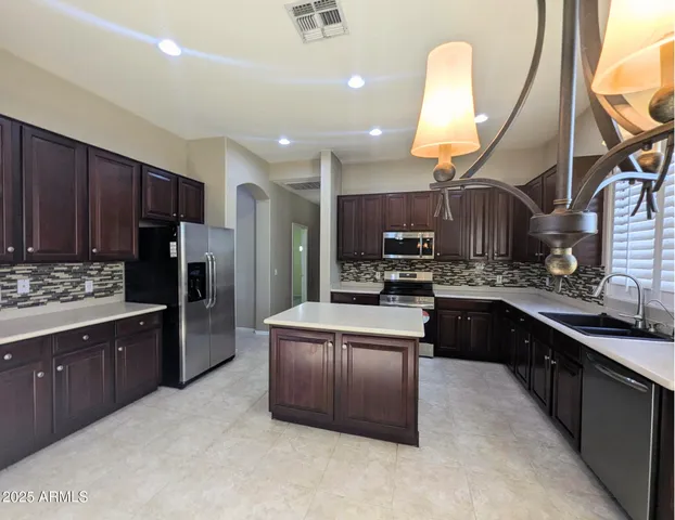 a kitchen with a stove sink and cabinets