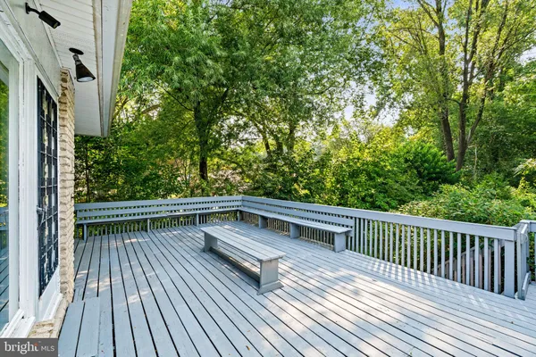 a view of balcony with wooden floor and fence