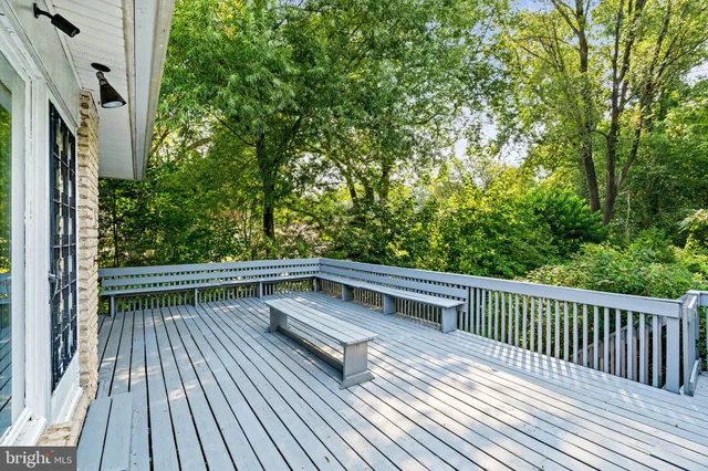 a view of balcony with wooden floor and fence