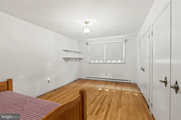 a view of a room with wooden floor and bathroom