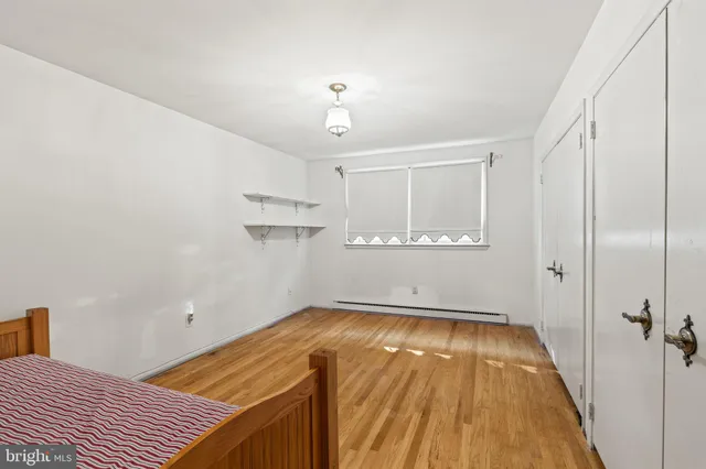 a view of a room with wooden floor and bathroom