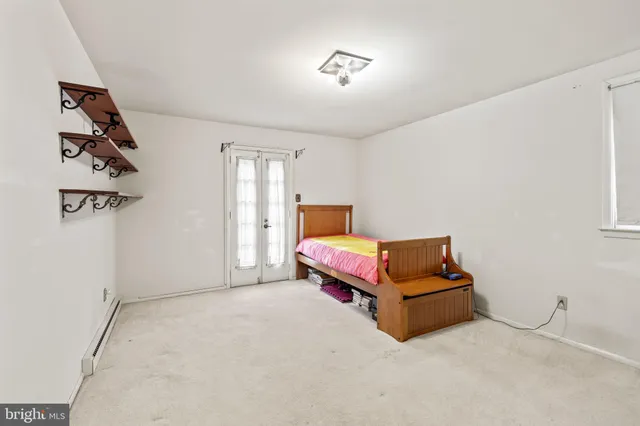 a spacious bedroom with a bed and cabinets