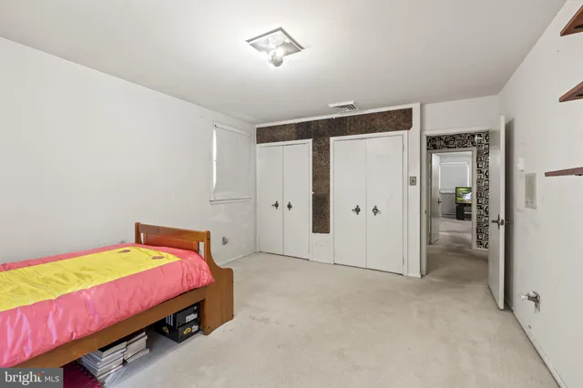 a bedroom with bed and a closet