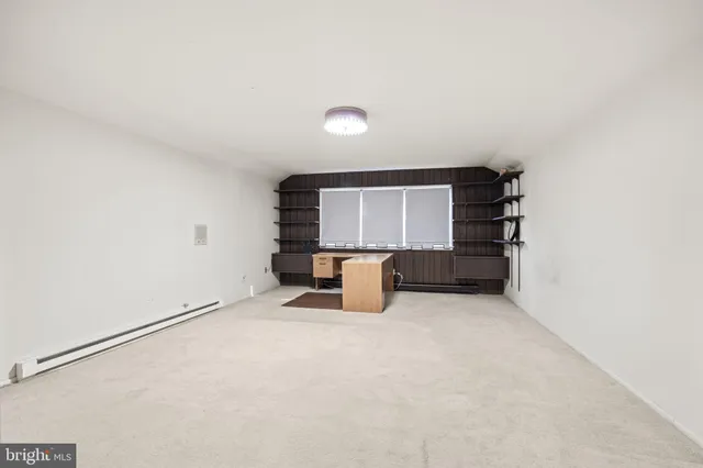 an empty room with furniture and natural light