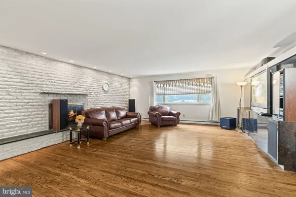 a living room with furniture window and a wooden floor