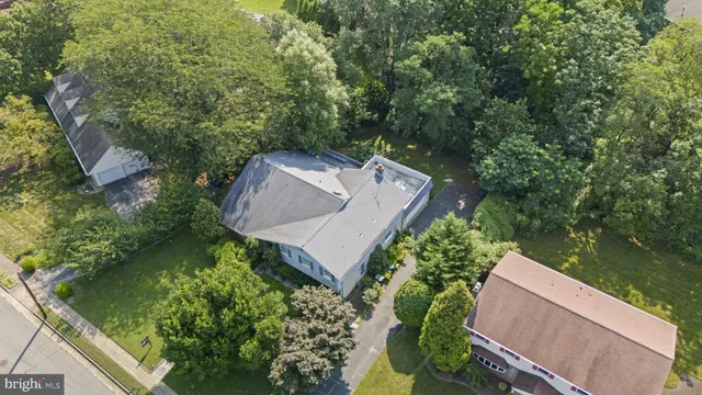 an aerial view of a house with a yard and garden