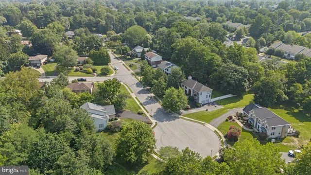 an aerial view of a house with a garden and lake view