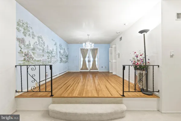 a living room with a bathtub and a chandelier