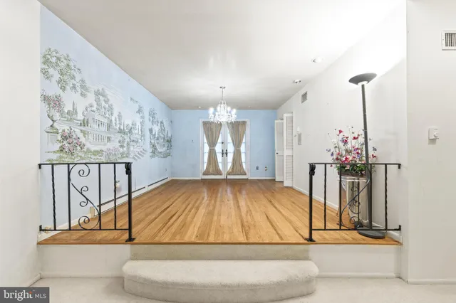 a living room with a bathtub and a chandelier