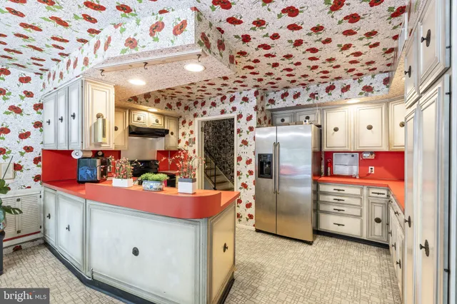 a kitchen with stainless steel appliances kitchen island granite countertop a refrigerator and a stove