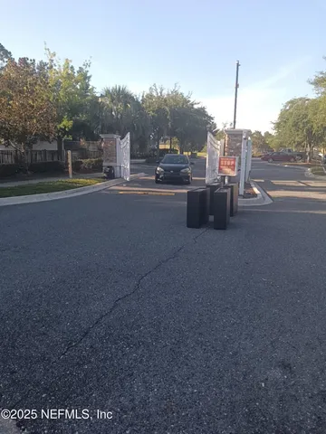 a view of outdoor space with signage and flags