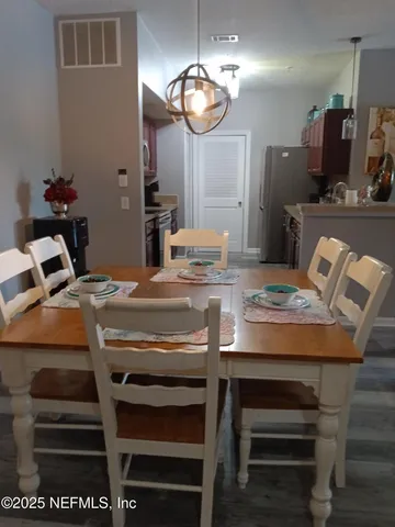 a kitchen with a table chairs and cabinets