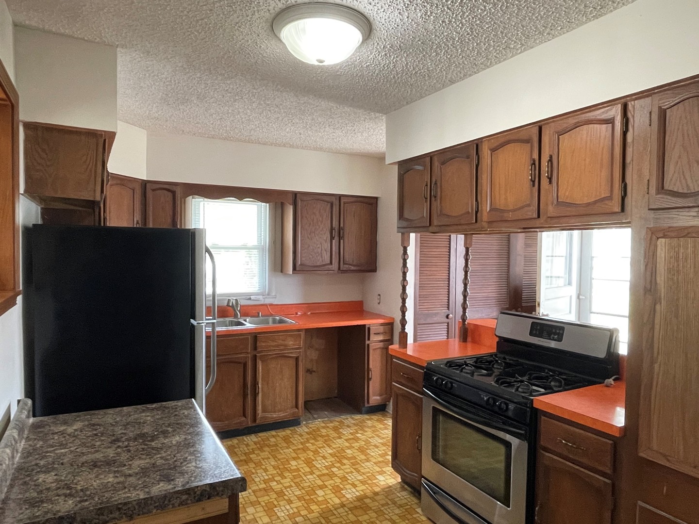 245 South Elm Street Herscher, IL 60941 - Photo 7 of 18 a kitchen with stainless steel appliances granite countertop a stove a refrigerator and a sink