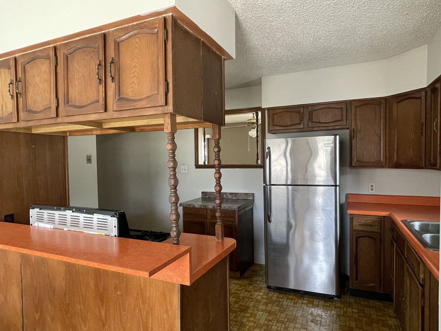 245 South Elm Street Herscher, IL 60941 - Photo 8 of 18 a kitchen with stainless steel appliances granite countertop a refrigerator a stove and a sink with wooden cabinets
