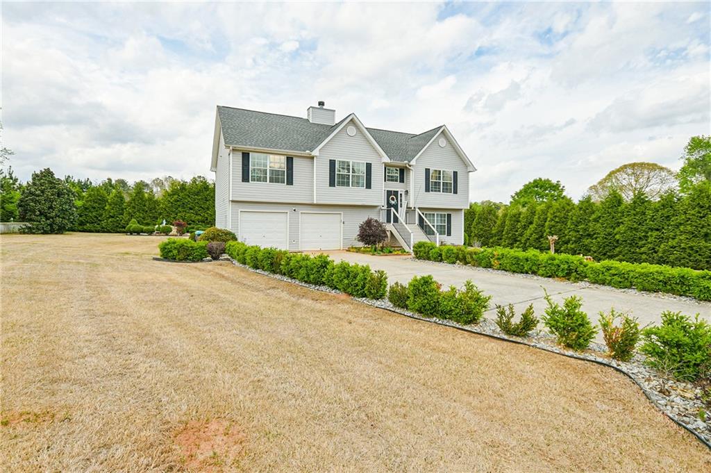 220 Prairie Hen Lane Hampton, GA 30228 - Photo 1 of 1 a front view of a house with a yard and garage