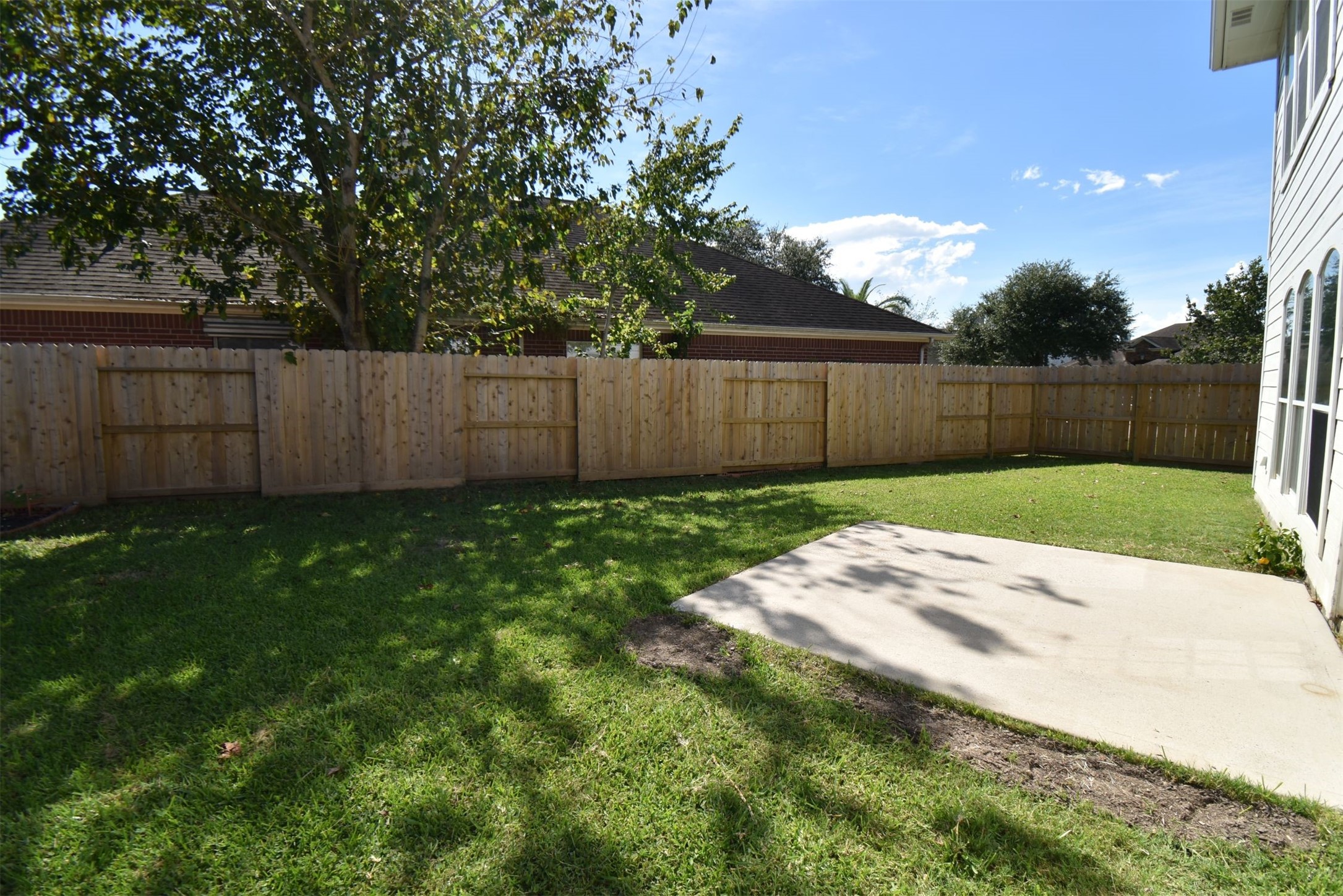 611 Chase More Court Bacliff, TX 77518 - Photo 16 of 20 a view of a backyard with potted plants and wooden fence