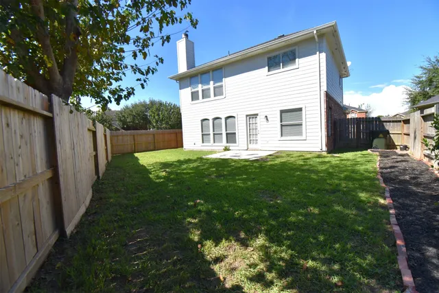 a view of a house with a yard and sitting area