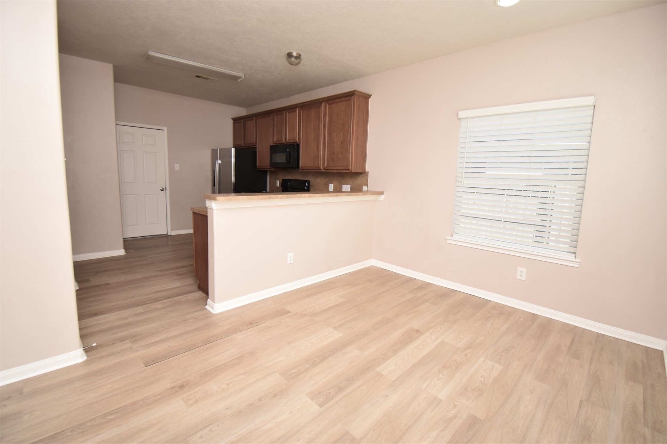 611 Chase More Court Bacliff, TX 77518 - Photo 4 of 20 a view of a room with wooden floor and a window