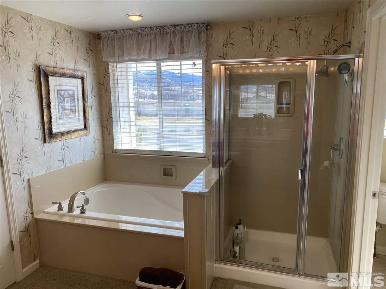 2150 Overland Road Reno, NV 89521 - Photo 12 of 19 a bathroom with a bathtub and a shower