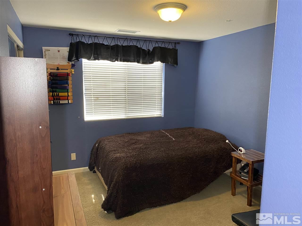 2150 Overland Road Reno, NV 89521 - Photo 13 of 19 a bed sitting in a bedroom next to a window
