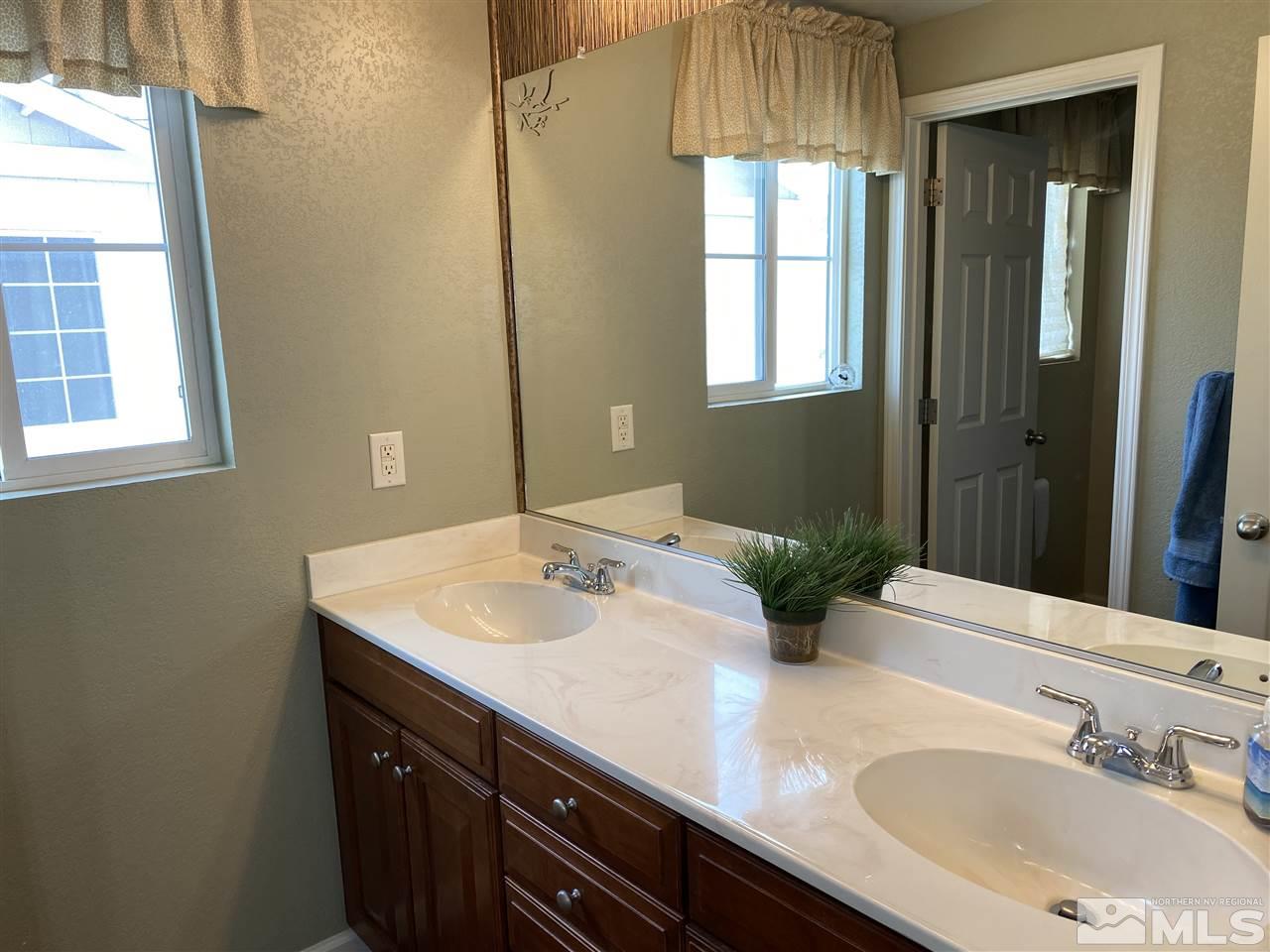 2150 Overland Road Reno, NV 89521 - Photo 16 of 19 a bathroom with a sink and a mirror