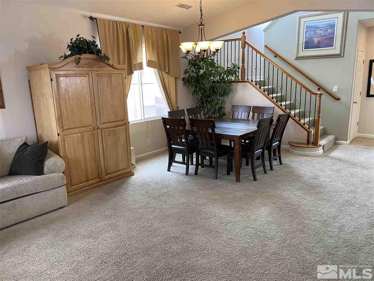 2150 Overland Road Reno, NV 89521 - Photo 4 of 19 a view of a dining room with furniture and front door