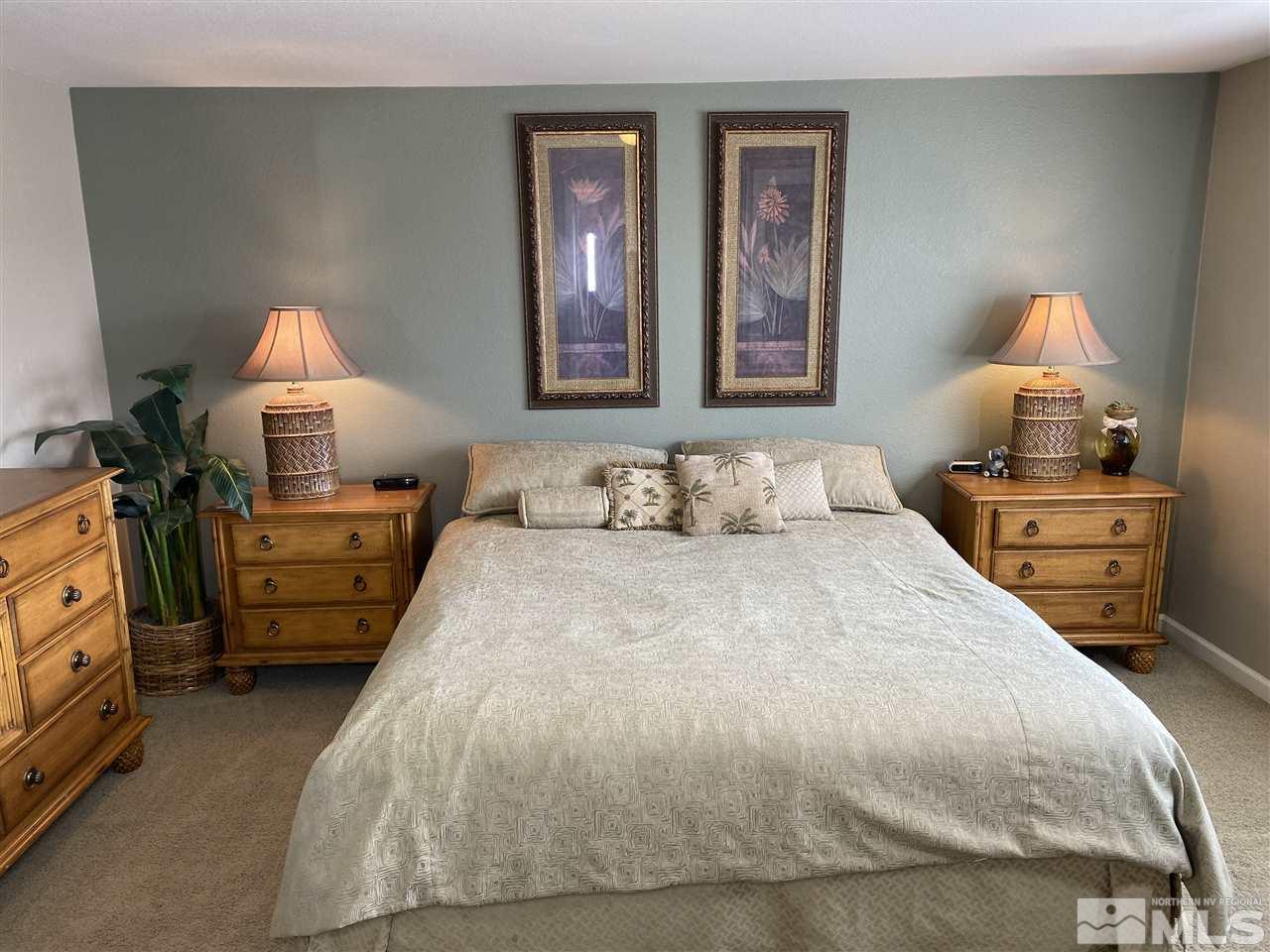 2150 Overland Road Reno, NV 89521 - Photo 9 of 19 a bedroom with a bed and a lamp on dresser
