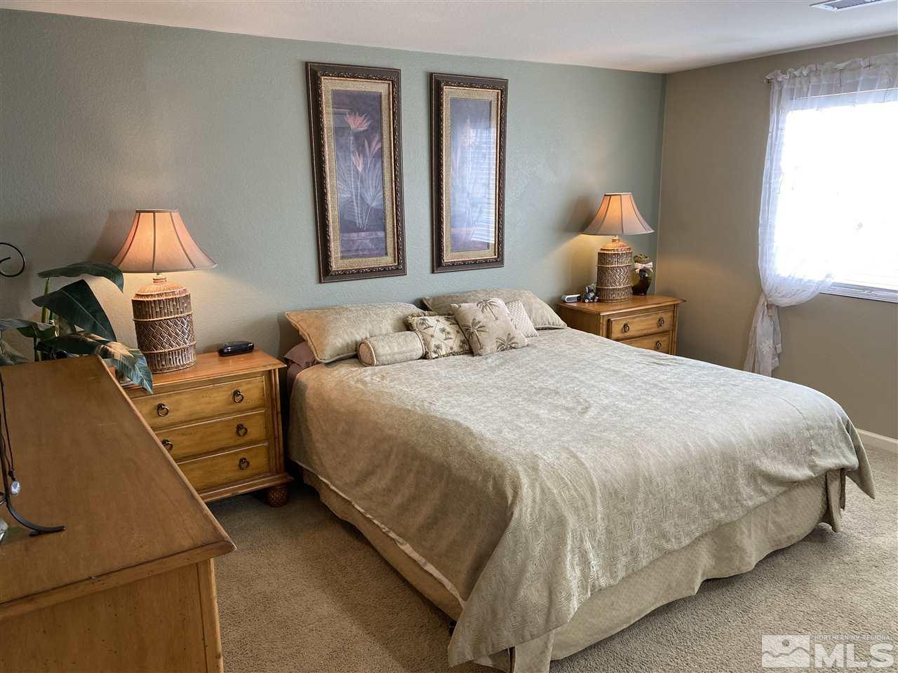 2150 Overland Road Reno, NV 89521 - Photo 10 of 19 a bedroom with a bed and a lamp