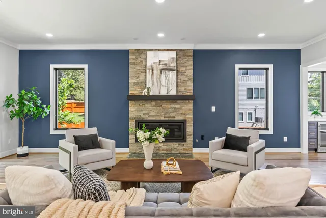 a living room with lots of furniture and a wooden floor
