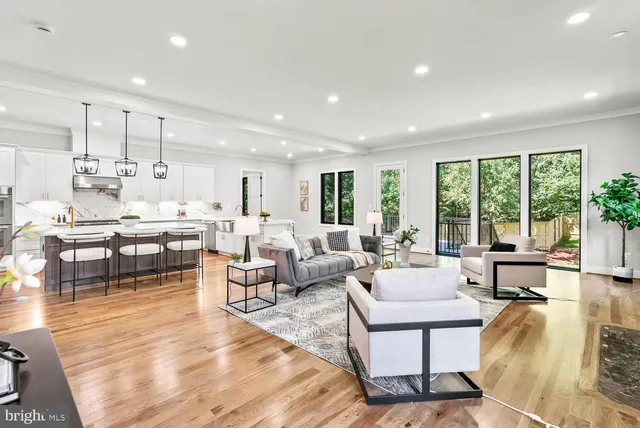 a kitchen with stainless steel appliances kitchen island granite countertop a table and chairs in it