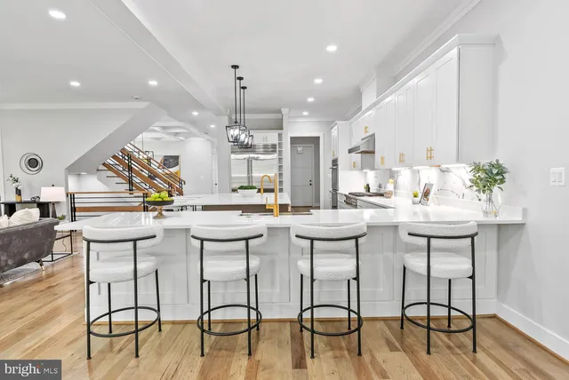 a view of a room with wooden floor and windows