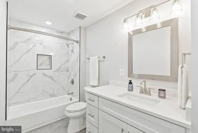 a kitchen with white cabinets and a sink