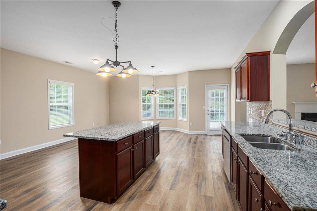 6054 Locklear Way Douglasville, GA 30134 - Photo 11 of 36 a kitchen with granite countertop counter space a sink appliances and a window