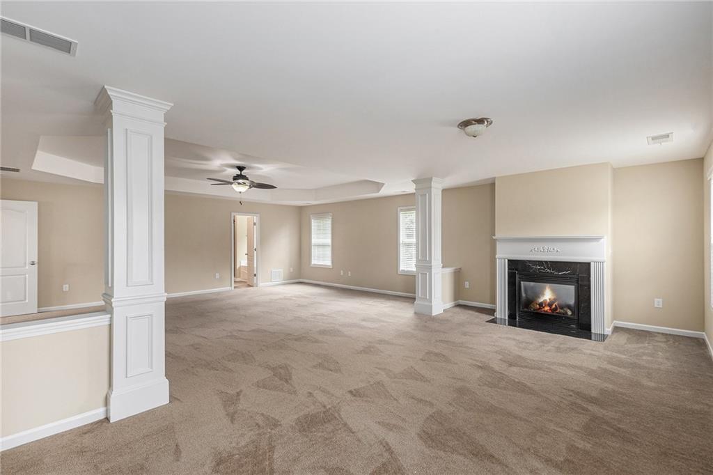 6054 Locklear Way Douglasville, GA 30134 - Photo 20 of 36 an empty room with windows and fireplace