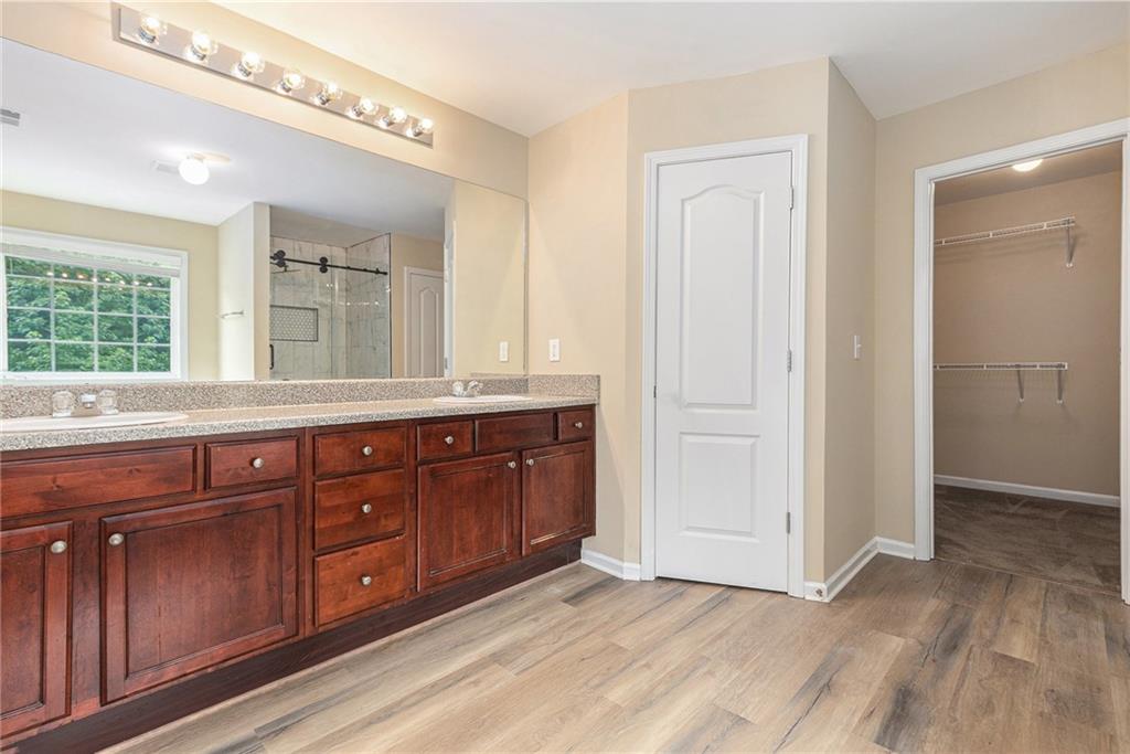 6054 Locklear Way Douglasville, GA 30134 - Photo 21 of 36 a spacious bathroom with a granite countertop sink mirror and