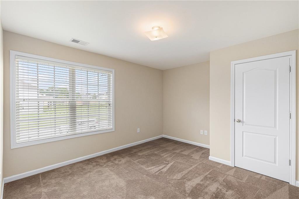 6054 Locklear Way Douglasville, GA 30134 - Photo 25 of 36 a view of an empty room with a window
