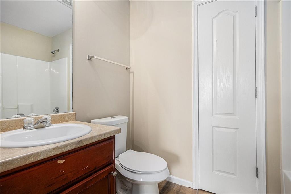 6054 Locklear Way Douglasville, GA 30134 - Photo 26 of 36 a bathroom with a granite countertop toilet and a sink