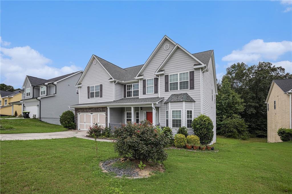 6054 Locklear Way Douglasville, GA 30134 - Photo 3 of 36 a front view of a house with a yard and potted plants