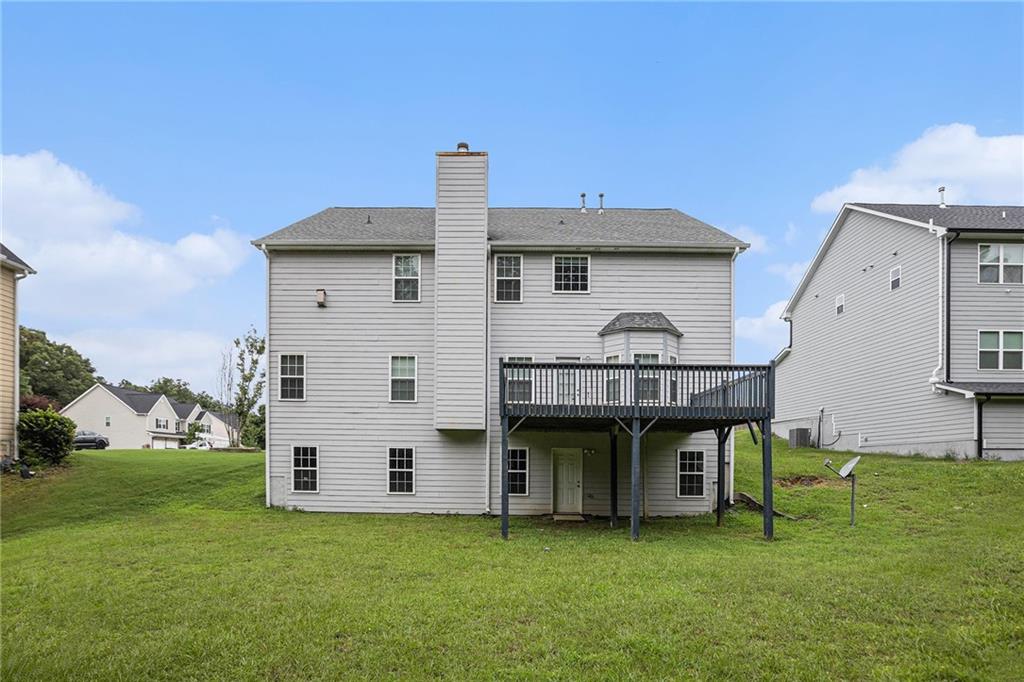 6054 Locklear Way Douglasville, GA 30134 - Photo 31 of 36 a view of a house with a backyard