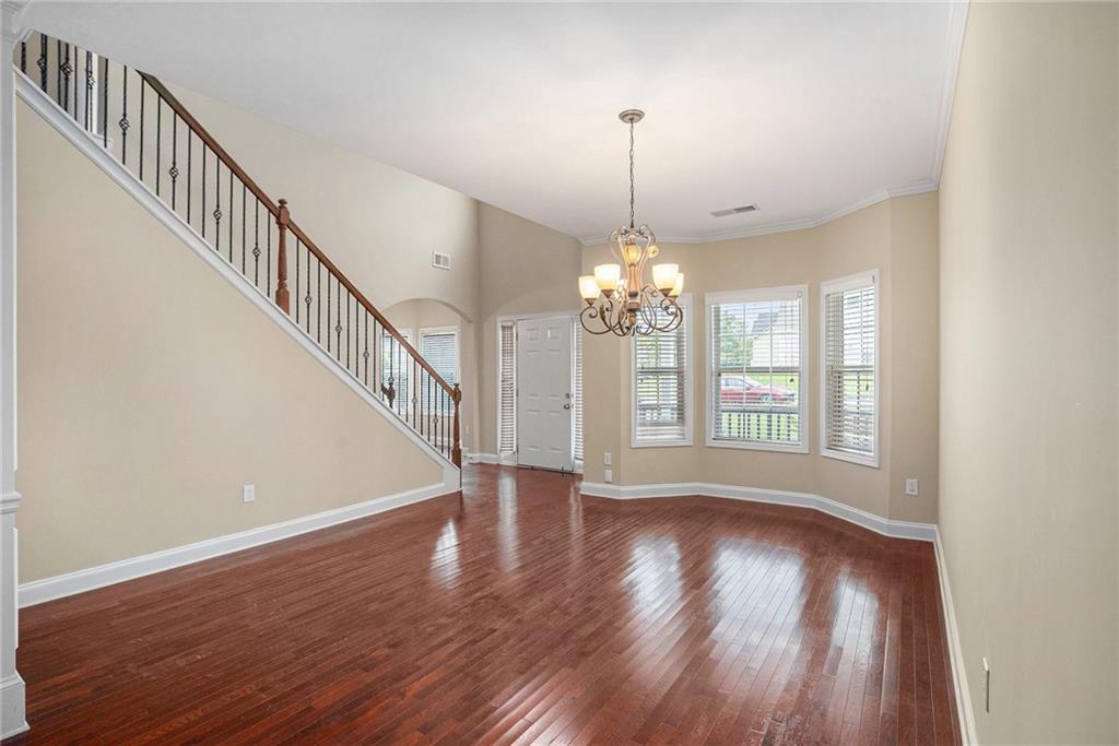 6054 Locklear Way Douglasville, GA 30134 - Photo 4 of 36 a view of an empty room with wooden floor and a window