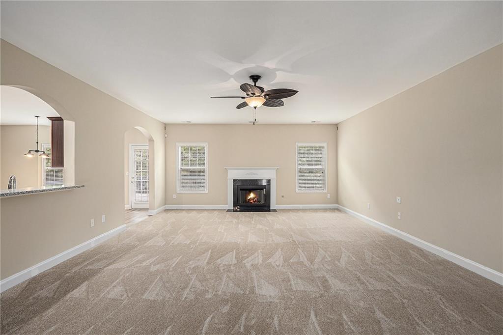 6054 Locklear Way Douglasville, GA 30134 - Photo 7 of 36 a view of an empty room with a fireplace and a window