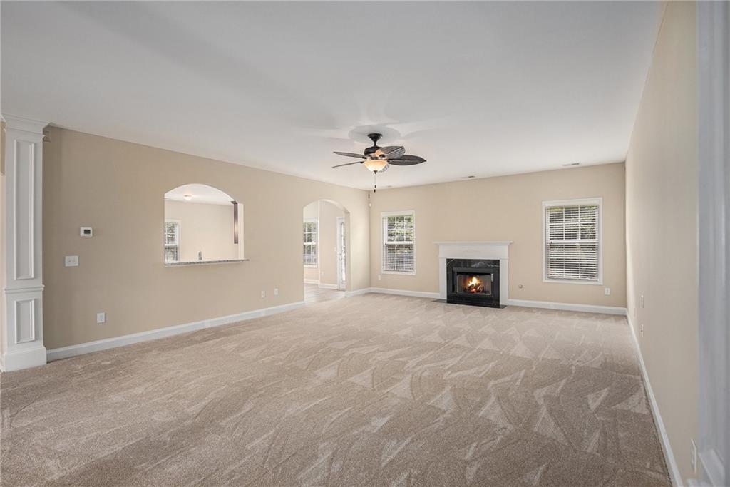 6054 Locklear Way Douglasville, GA 30134 - Photo 8 of 36 an empty room with windows and fireplace
