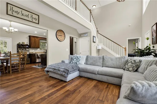 a view of a dining room with furniture a chandelier and wooden floor