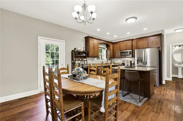 a kitchen with stainless steel appliances granite countertop a refrigerator stove microwave and sink