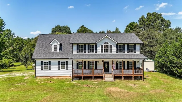 a aerial view of a house with a yard table and chairs