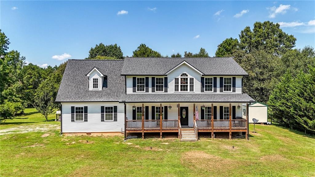 923 County Line Road Resaca, GA 30735 - Photo 2 of 49 a aerial view of a house with a yard table and chairs