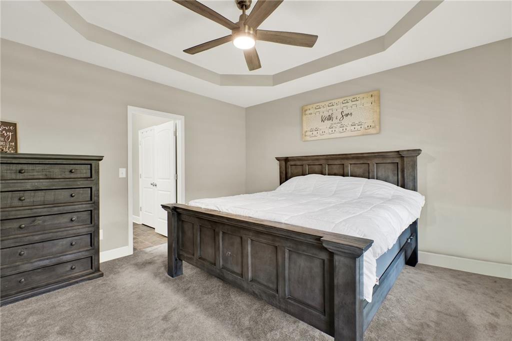 923 County Line Road Resaca, GA 30735 - Photo 24 of 49 a bedroom with a bed and a chandelier