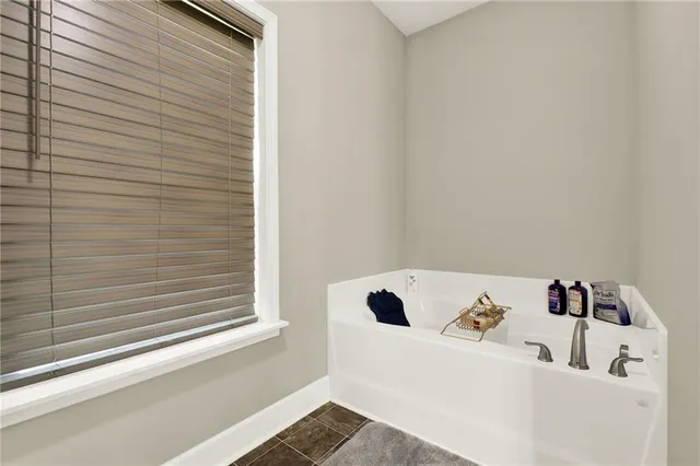 a view of a hallway with wooden floor and a window
